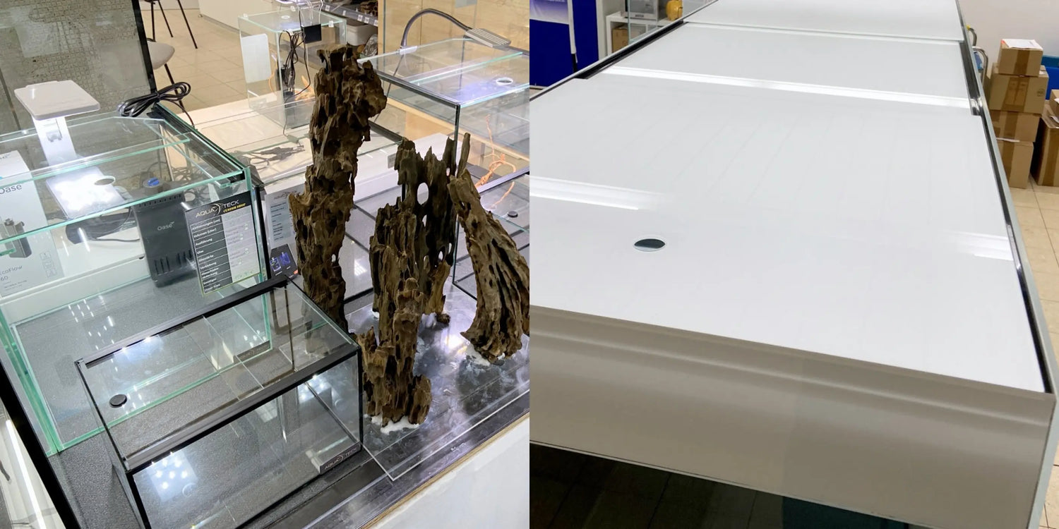 AQUA TECK Showroom: Maßgefertigte Aquarien in verschiedenen Größen mit schwarzem Kies und Mangrovenwurzel-Dekoration (links), sowie eine hochwertige weiße Aluminium-Aquariumabdeckung in der Detailansicht (rechts)